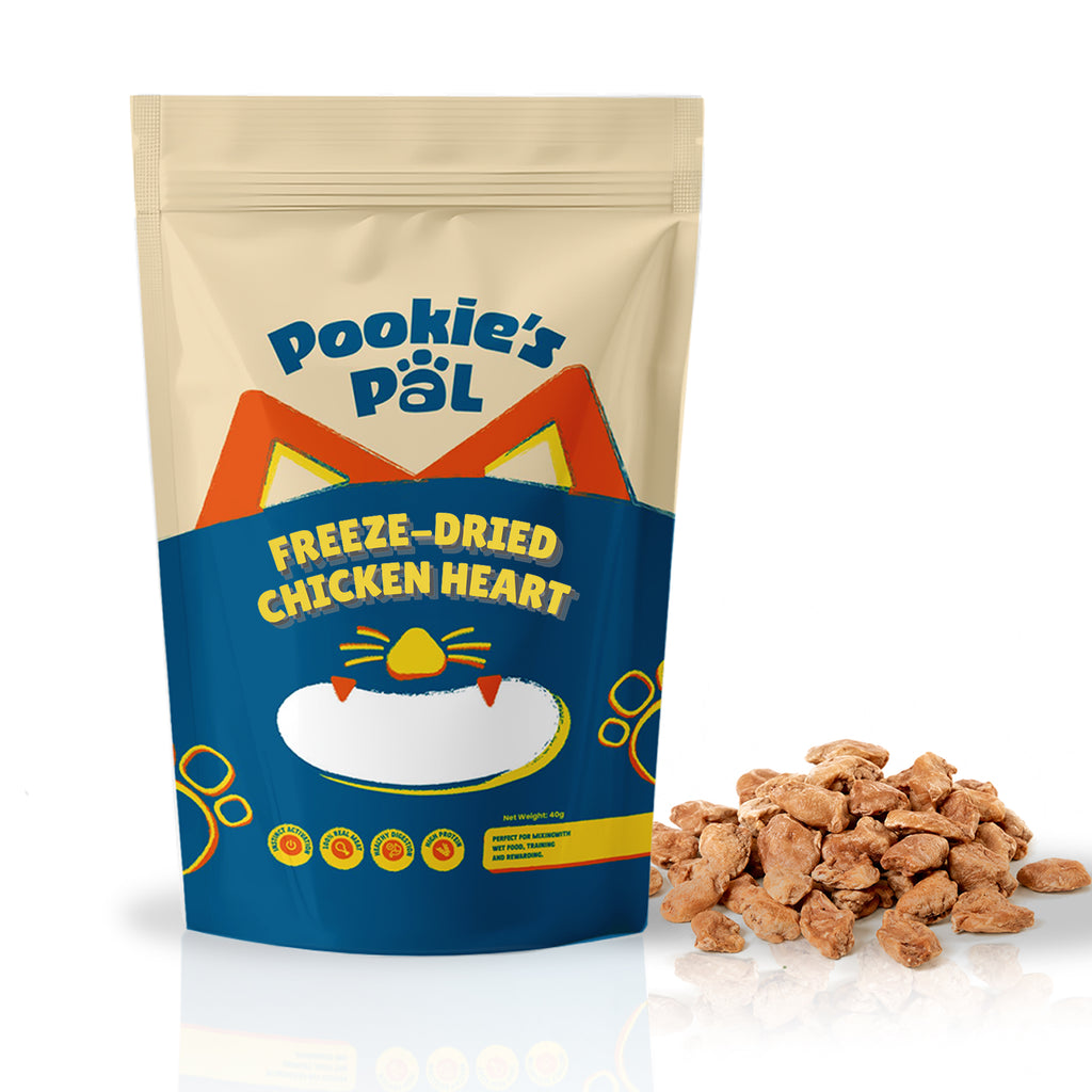 A stand-up pouch of Pookie's Pal Freeze-Dried Chicken Heart cat treats shown on a white background, with a small pile of the brown freeze-dried treats placed beside it.